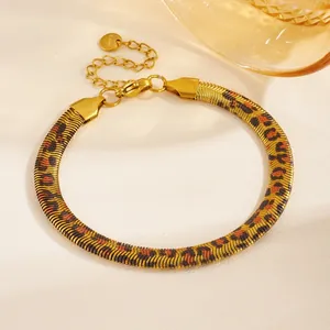 Macro view of gold PVD stainless steel snake chain bracelet with leopard print pattern