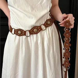 Bohemian brown decorative waist belt with metal rings and floral charms on white dress
