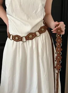 Bohemian style suede waist chain with floral details and long fringe elements.