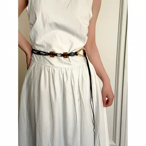 Detail view of a handcrafted bohemian woven waist belt with ethnic beads and turquoise