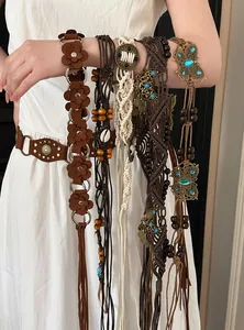 Detailed close-up of assorted Bohemian style waist belts with flower and butterfly motifs