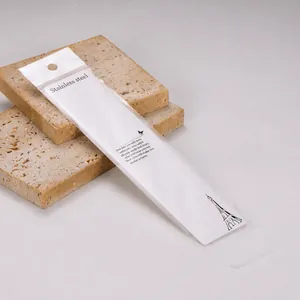 Detailed view of long white necklace display card and clear OPP bag packaging set
