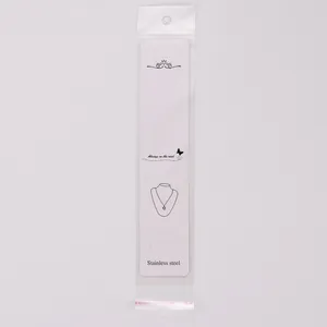 Detail view of long white paper jewelry display card with OPP packaging bag