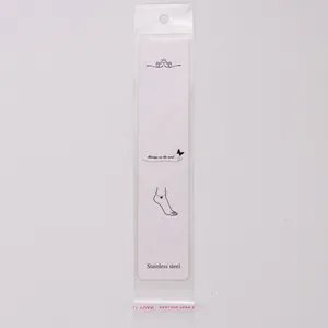 Close-up detail view of a long white jewelry display card inside a transparent OPP plastic bag.