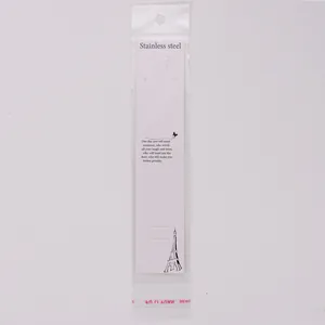 Detail showing a white long necklace display card with a clear OPP bag for jewelry packaging.