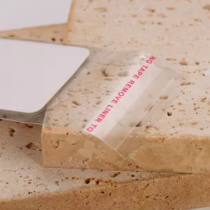 Detail of white jewelry display card inside self-adhesive transparent OPP packaging bag