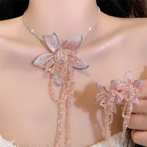 Close-up detail of elegant French style pink floral tassel necklace and earrings set