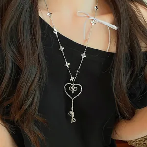 Vista detallada de un elegante collar con llave en forma de corazón y detalles de flores