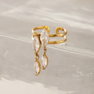 Detailed view of a gold adjustable ring featuring dangling marquise-cut cubic zirconia stones.