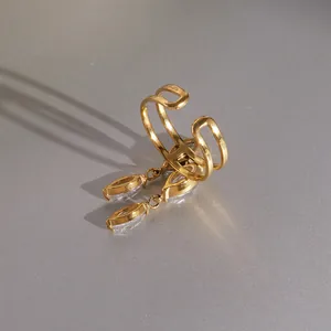 Close-up detail of a gold-plated stainless steel adjustable ring with dangling marquise zircons