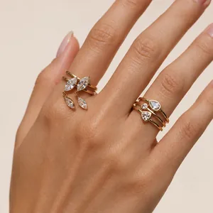 Detailed macro view of elegant gold-plated stacking rings with zircon on a hand