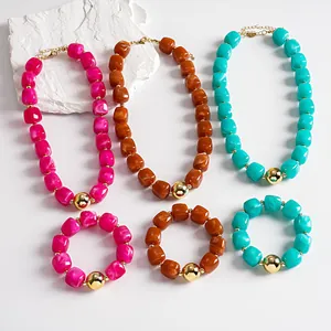 Detailed view of chunky marbled acrylic necklace and bracelet sets in vibrant colors