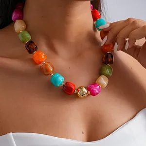 Close-up detail of colorful chunky acrylic necklace with marbled geometric beads