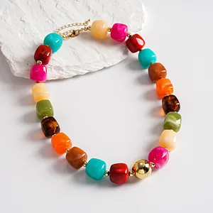 Close-up of vibrant marbled acrylic beads on a chunky geometric collar necklace.