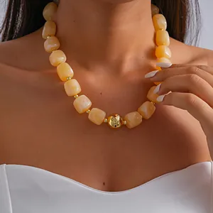 Detail view of marbled acrylic chunky necklace with a central gold metallic bead