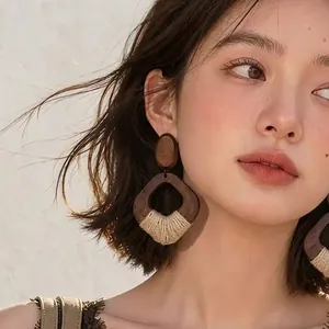 Close-up of bohemian style raffia woven wooden drop earrings on a young Asian model