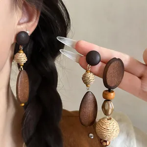 Bohemian raffia woven and wood drop earrings for women with a resort style design features