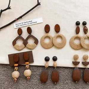 Detailed view of bohemian raffia woven earrings with wooden accents and textures