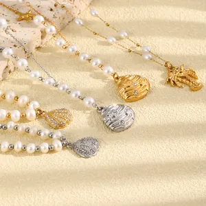 Elegant ocean themed pearl necklace collection with shell and palm tree charms in gold