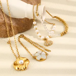 Detail showing the exquisite shell and flower pendants on 18K gold-plated chains