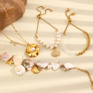 Detail view of ocean-themed jewelry with golden shells, flowers, and pearls.
