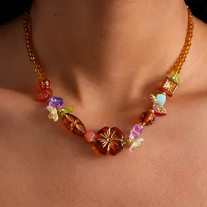 Vue détaillée d'un collier floral vintage ambré avec des perles en verre et acrylique