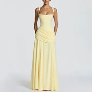 Detail of pale yellow sleeveless evening gown with ruched waist and flowing skirt