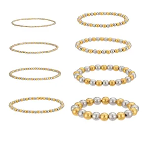 Vista dettagliata di bracciali elastici con perline in acciaio inossidabile oro e argento