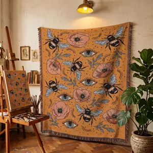 Artistic bee and poppy woven tapestry hanging in a vintage studio setting.