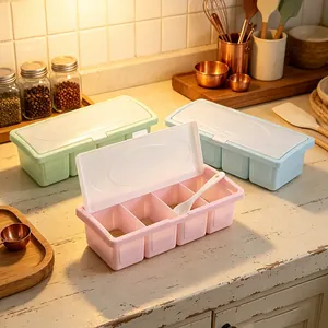 Pastel 4-compartment plastic seasoning boxes with lids and spoons in kitchen setting.