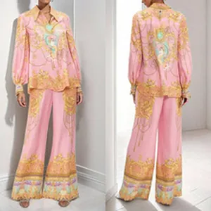 Detailed view of pink baroque print long-sleeve shirt and matching wide-leg trousers.