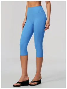 Detail of high-waisted blue brushed yoga capri leggings featuring a slim-fit athletic cut