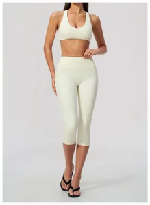 Full length detail of woman in cream high-waisted cropped yoga leggings and sports bra