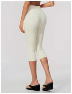 Back view of high-waisted cream yoga capris for women, showing sleek fit and calf length.