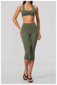 Full view of women's olive green high-waisted yoga capris and matching sports bra set