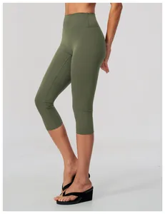 Side profile view of women's olive green high-waisted brushed yoga capri leggings