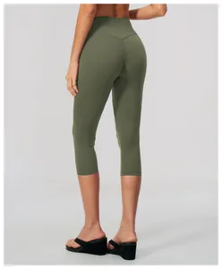 High-waisted olive green brushed yoga capri pants showing back view and slim fit