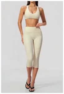 Front view of cream brushed yoga set featuring high-waisted capri pants and sports bra