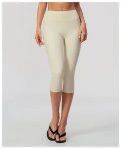 Detailed view showing the soft brushed texture of high-waist cream yoga capris on a model