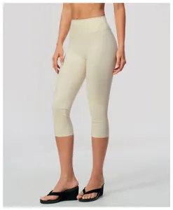 Close-up view of high-waisted brushed yoga capri pants for women in soft cream beige