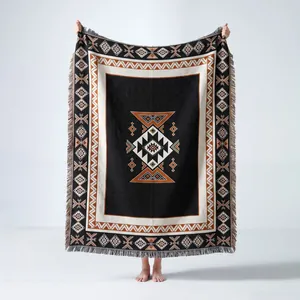 Bohemian style geometric woven camping blanket with fringes shown held up full view