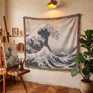 Woven tapestry throw blanket with Great Wave art hanging in a cozy art studio setting