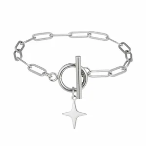 Close-up detail of stainless steel four-pointed star pendant on paperclip chain