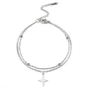 Close-up of a double-layered stainless steel anklet with a four-pointed star pendant