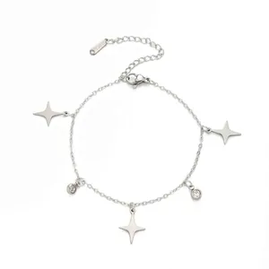 Detail shot of stainless steel bracelet with four-pointed star and crystal charms