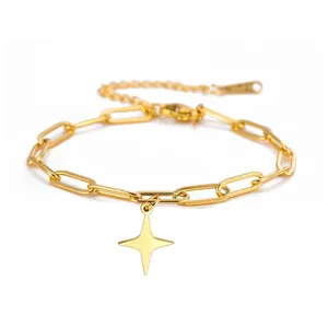 Close-up of a gold stainless steel paperclip chain bracelet with a four-pointed star pendant