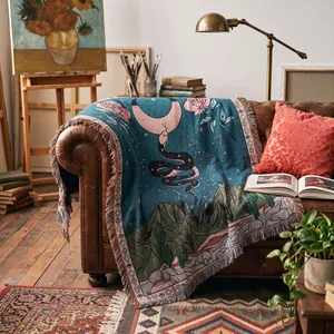 Detailed view of Bohemian woven throw blanket featuring snake and moon design on leather sofa