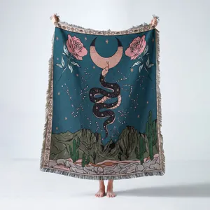 Bohemian woven blanket featuring mystical snake moon and desert scene pattern