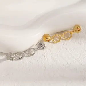 Macro view showing the detailed hollow frame of glasses shaped metal jewelry brooches