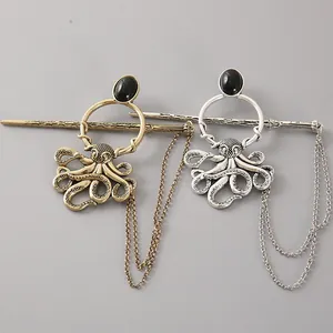Detailed macro view of vintage bronze and silver octopus hairpins with black stones